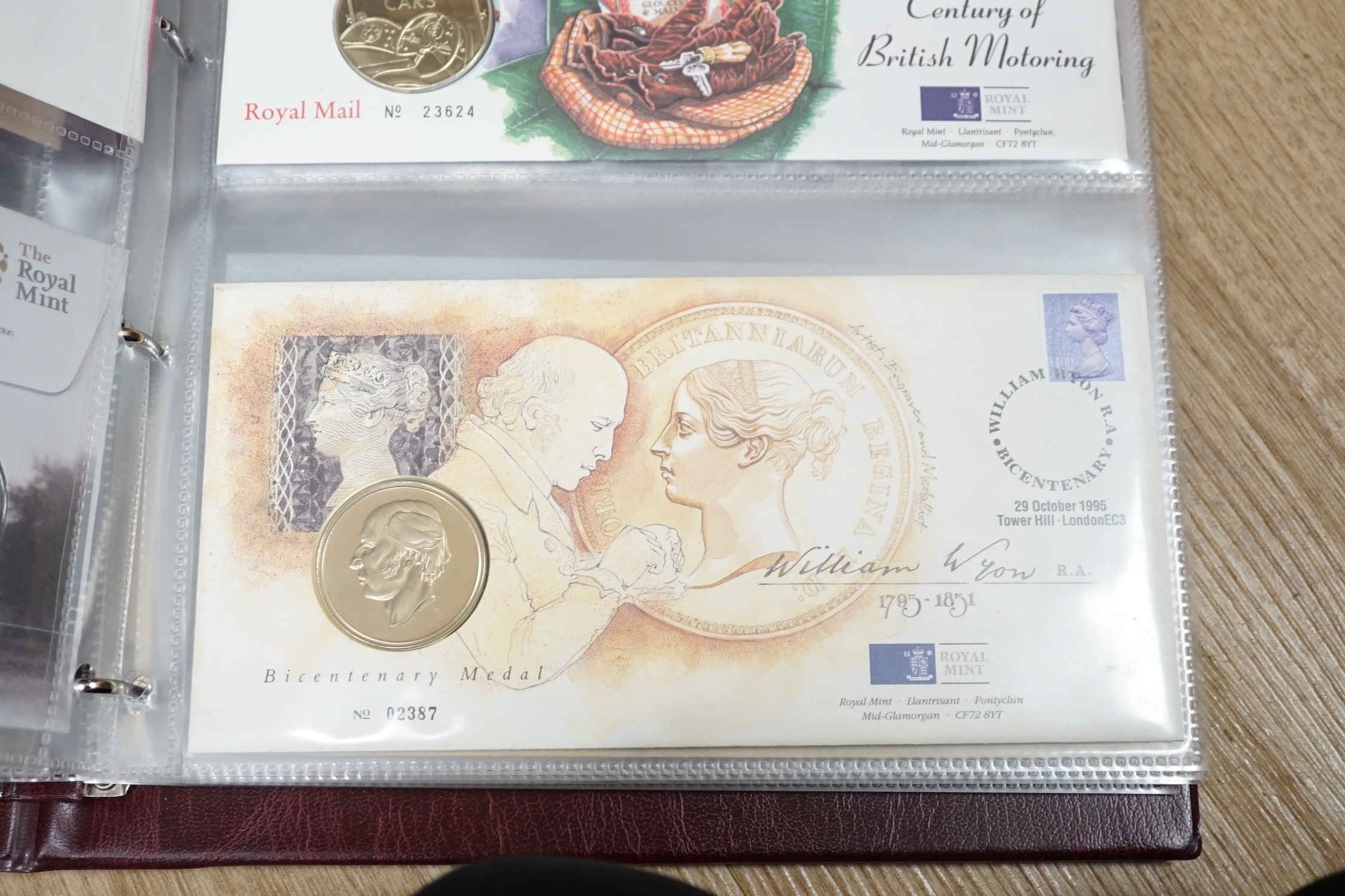 Coin and medallion First Day covers in three albums (54)